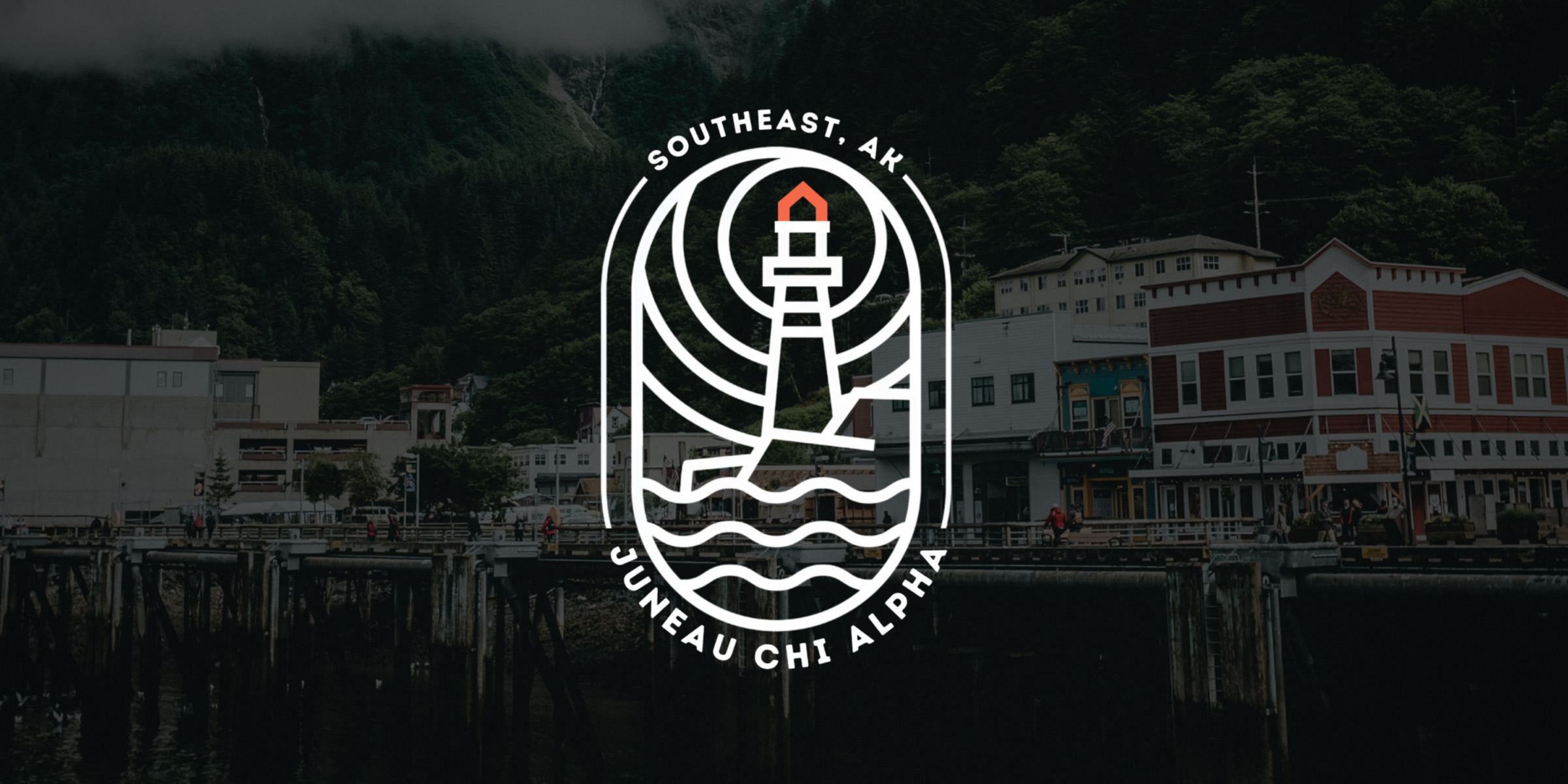 The Juneau waterfront with the Juneau Chi Alpha lighthouse badge